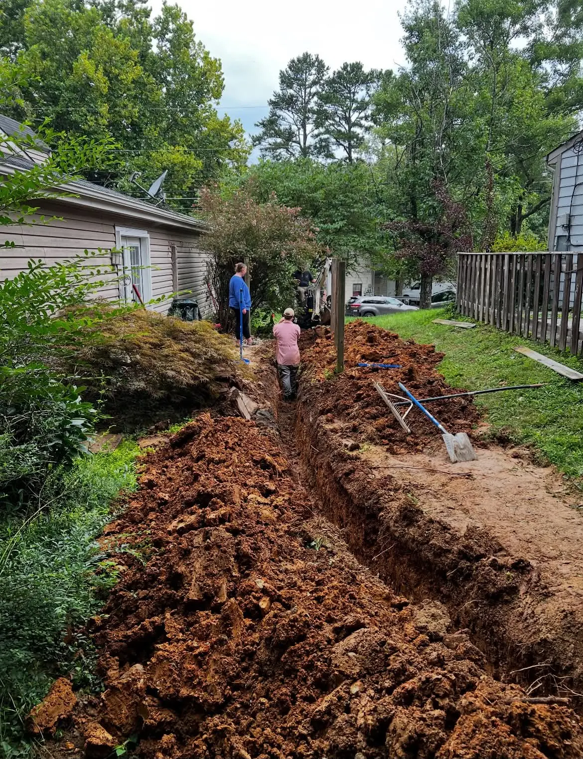 Long drainage trench opened behind home during excavation work