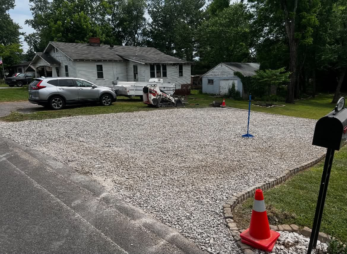 Driveway freshly graveled and graded after repair